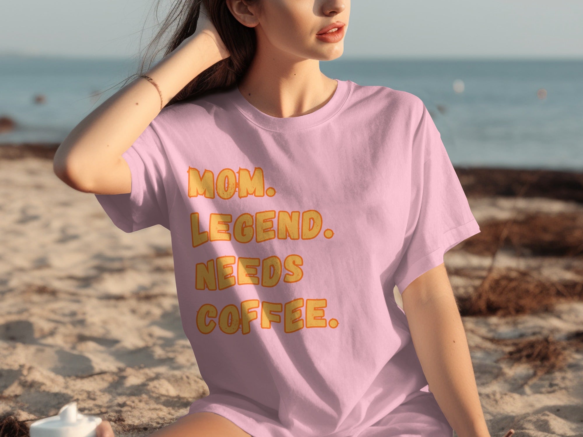 Pink t-shirt with text: Mom. Legend. Needs Coffee.
