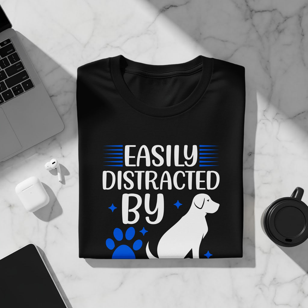 Black t-shirt with "Easily Distracted by" text, paw print, dog, and stars.