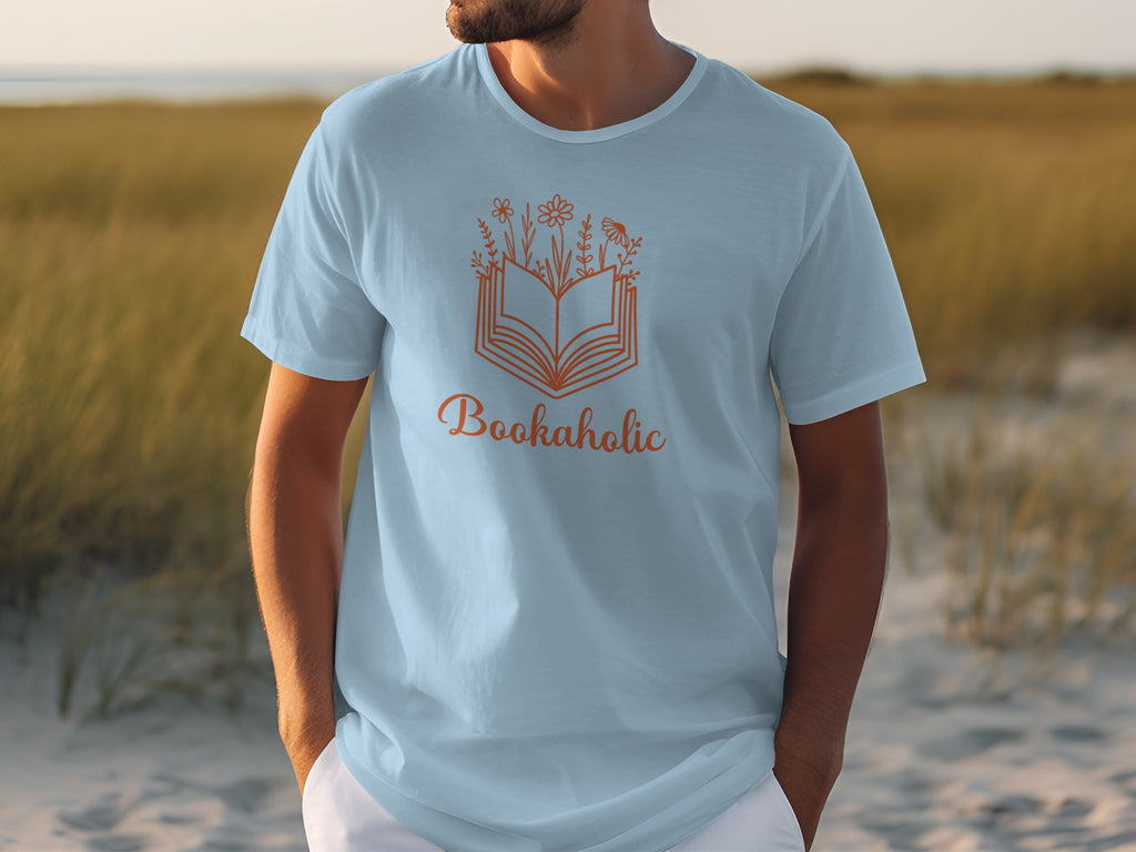 Light blue t-shirt with an orange "Bookaholic" design featuring an open book and flowers.