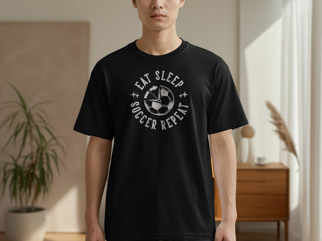 Black t-shirt with "Eat Sleep Soccer Repeat" text and a soccer ball graphic.