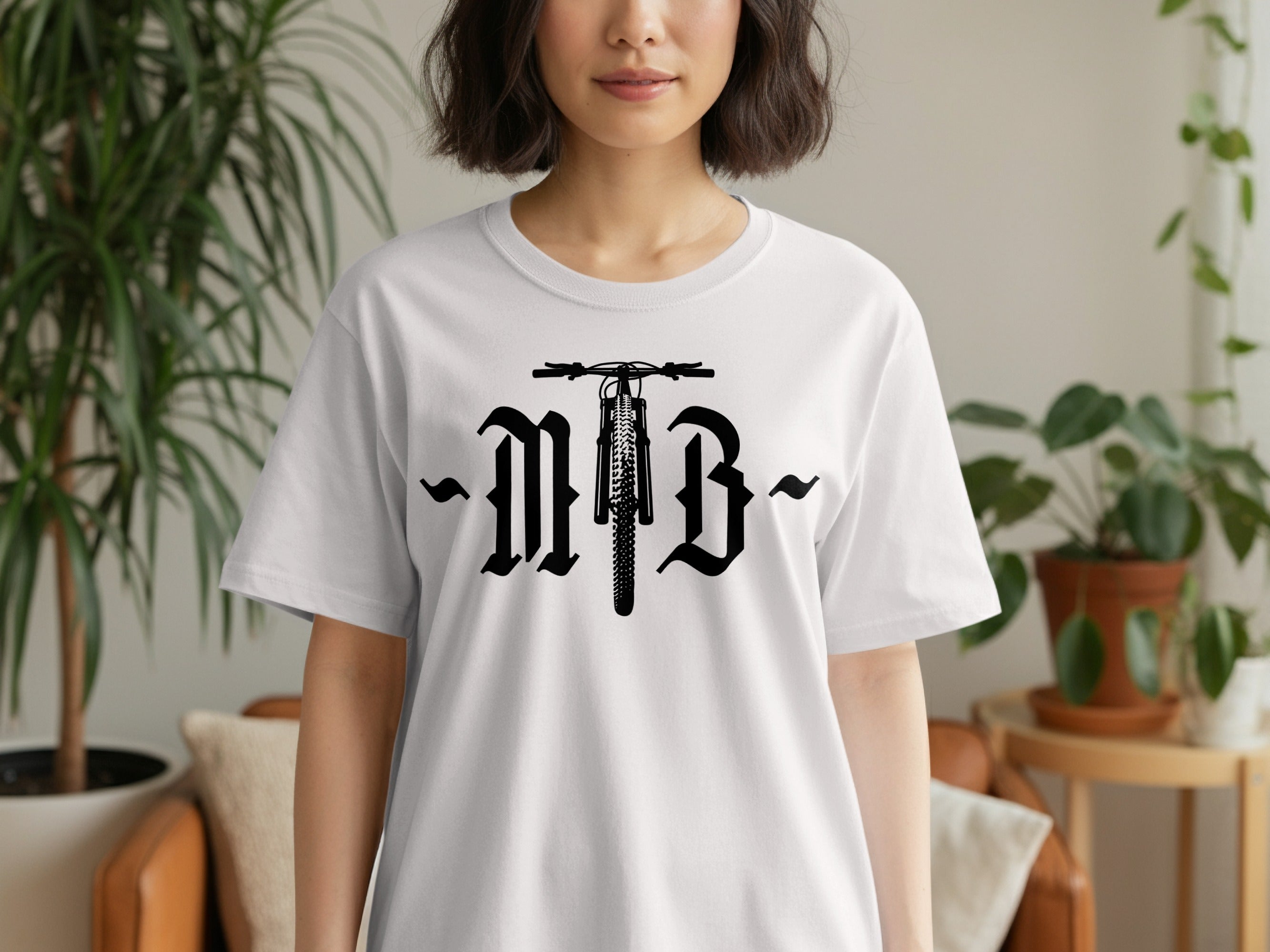 White t-shirt with black MTB graphic featuring a bicycle front wheel and gothic lettering.