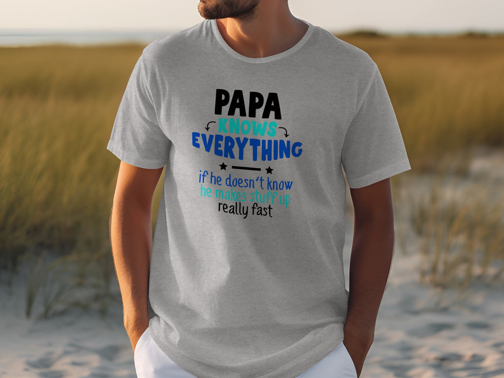 Grey t-shirt with text: Papa Knows Everything if he doesn't know he makes stuff up really fast.