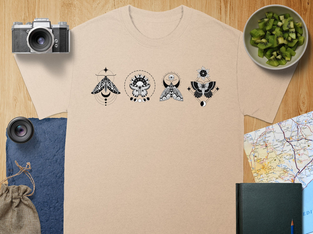 T-shirt with black celestial moth and sun designs.