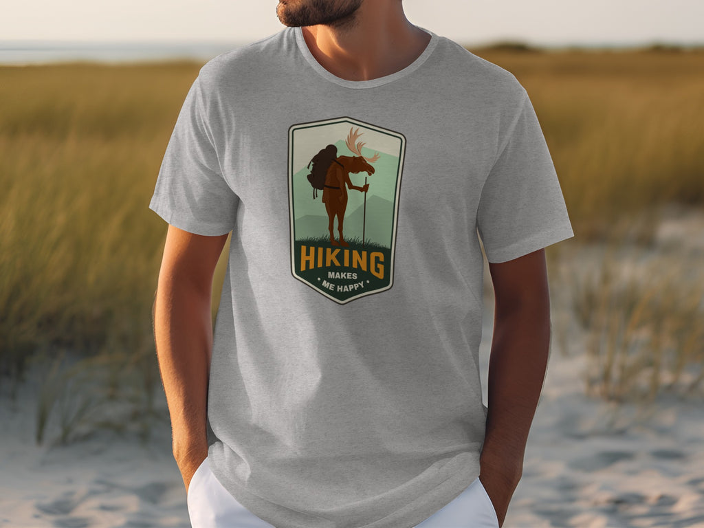 Gray t-shirt with a shield logo of a moose hiking, reads "Hiking Makes Me Happy".