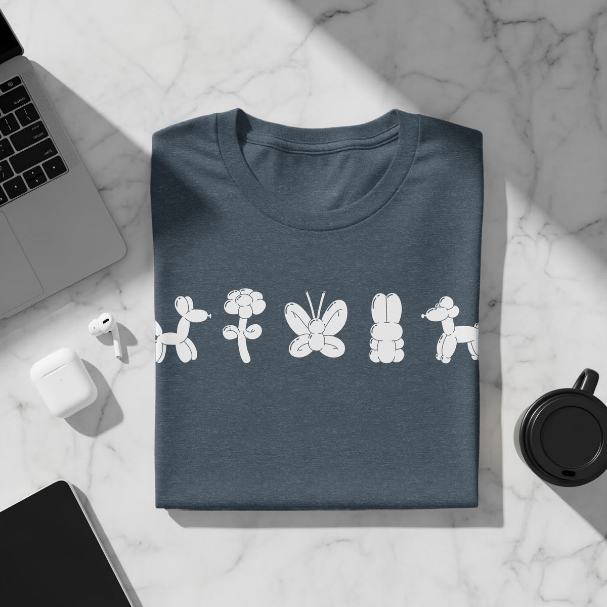 Dark teal t-shirt with white balloon animal print: dog, flower, butterfly, bunny, dog.