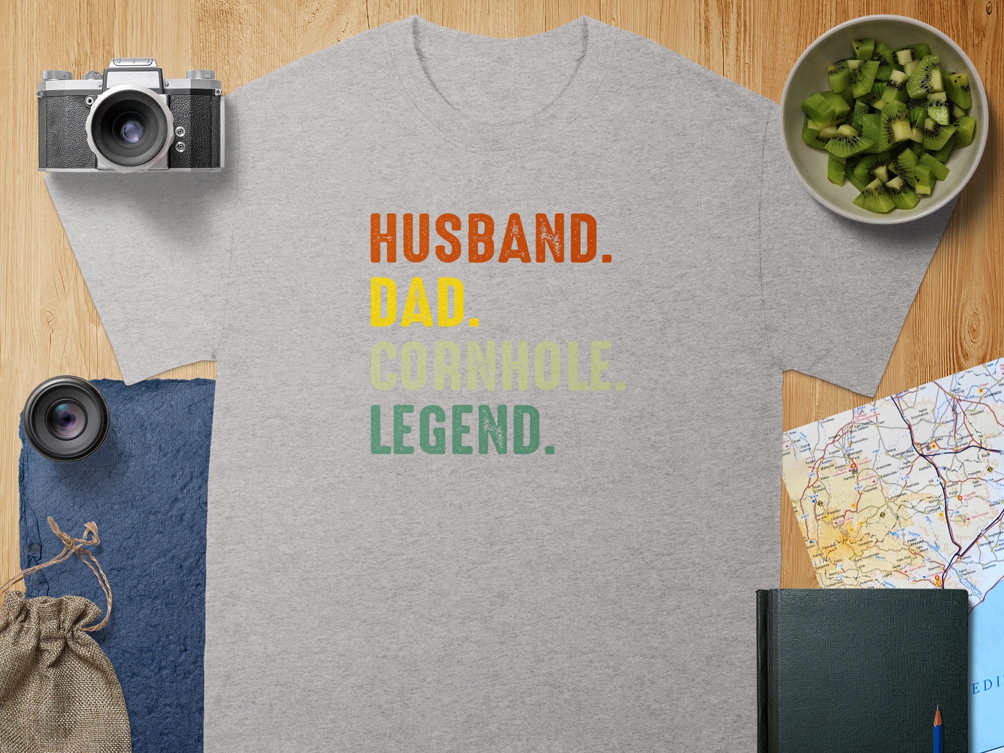 Grey t-shirt with text "Husband. Dad. Cornhole Legend."
