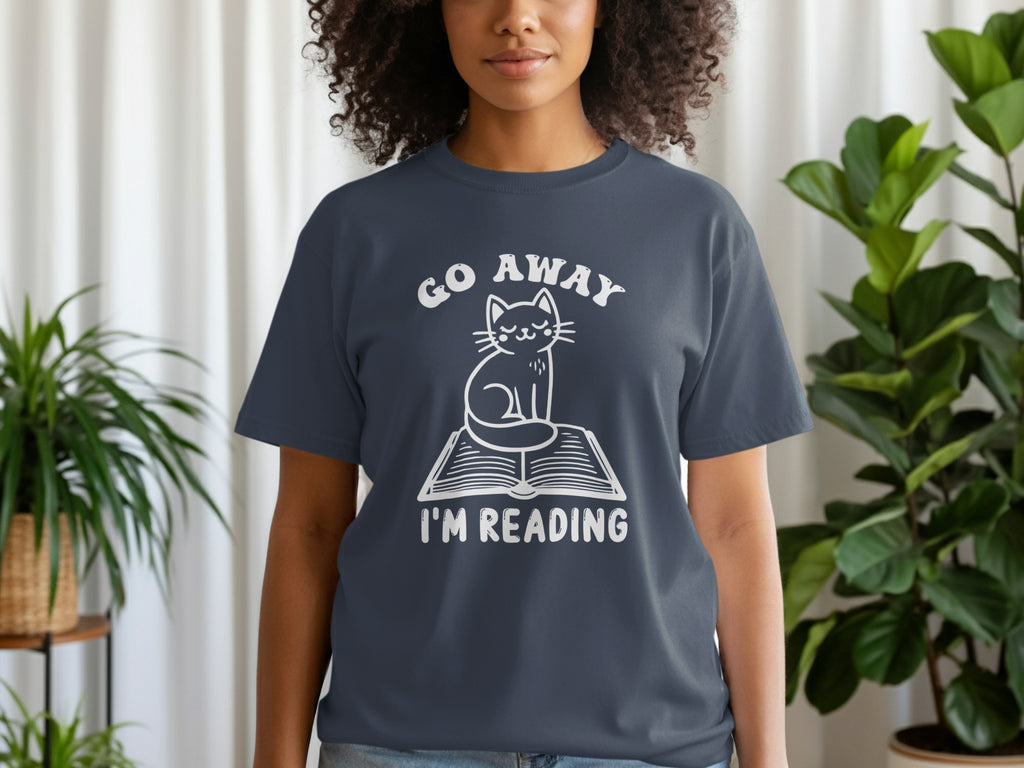 Dark gray t-shirt with a white graphic of a cat sitting on a book, saying "Go Away I'm Reading."
