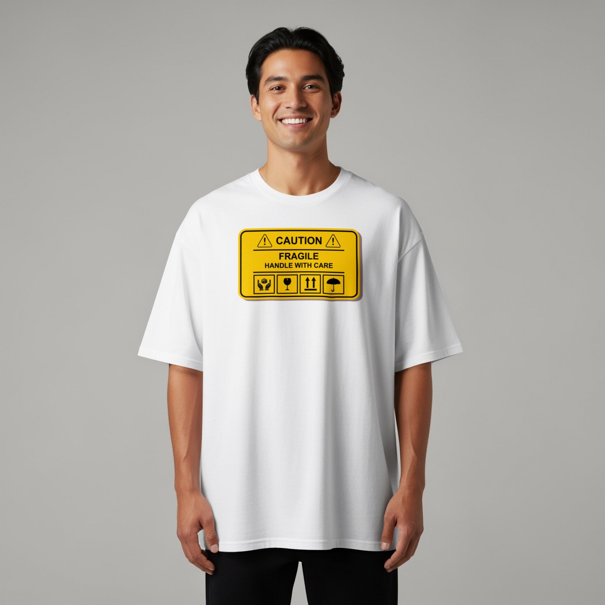White t-shirt with a yellow "CAUTION FRAGILE HANDLE WITH CARE" sign graphic.