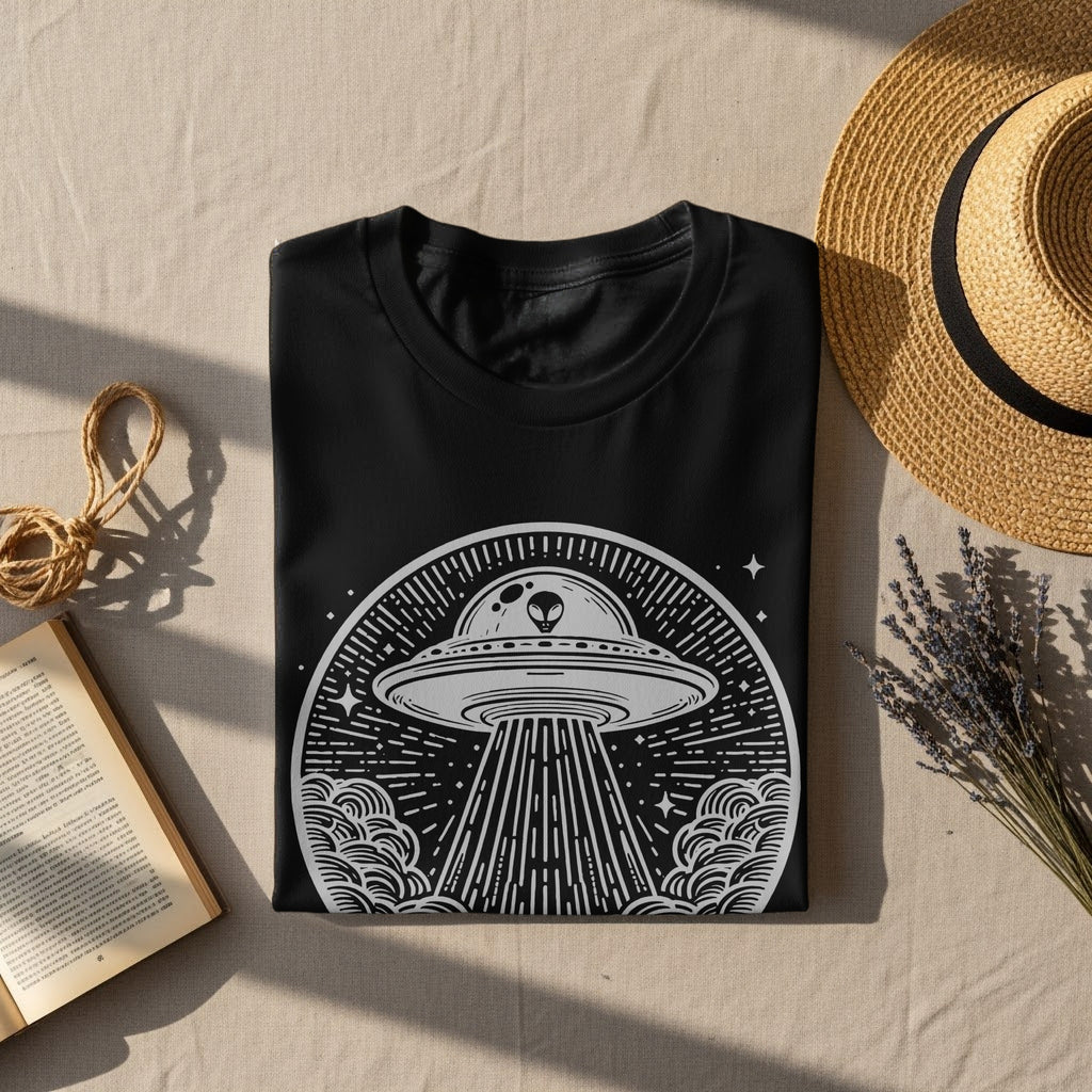 Black t-shirt with a white line art graphic of a UFO and alien.
