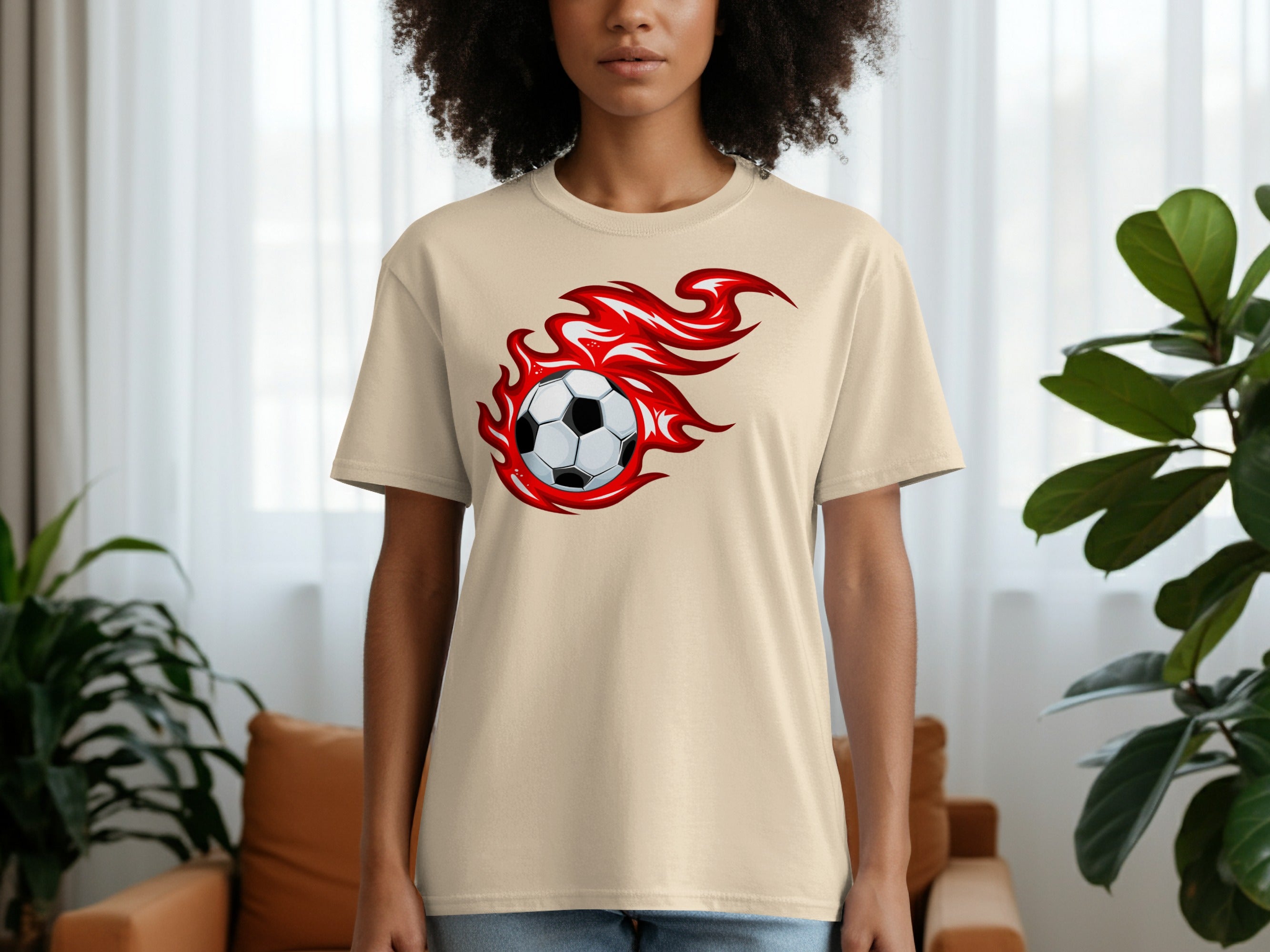 Light beige t-shirt with a graphic of a soccer ball engulfed in red flames.