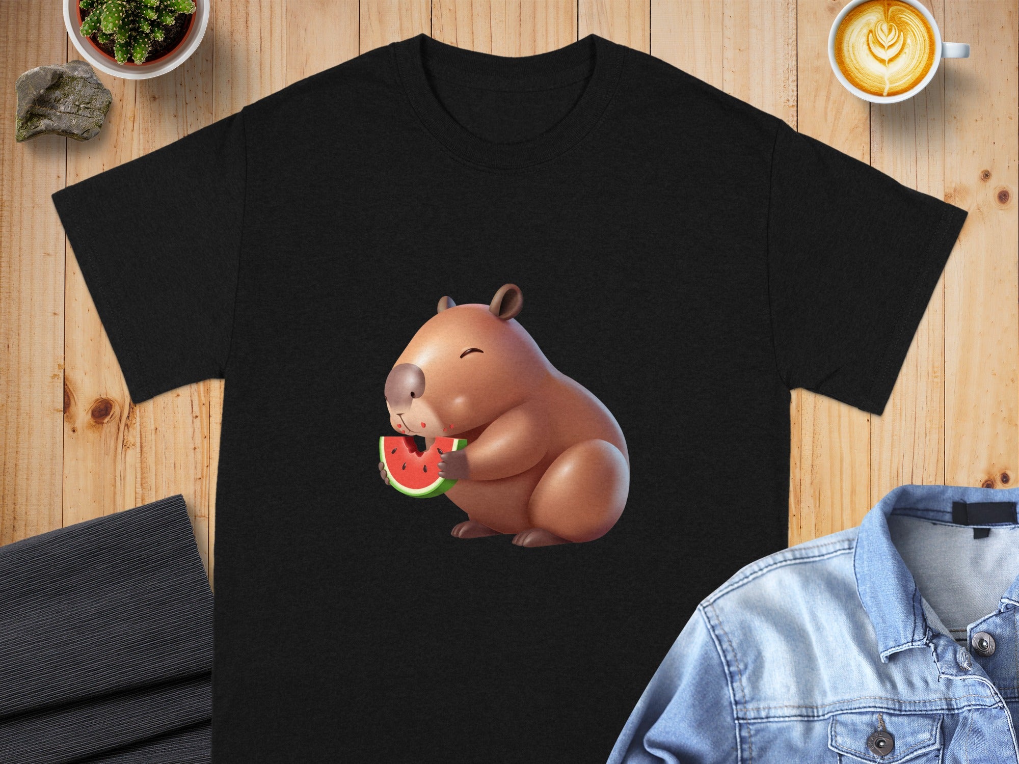 Black t-shirt featuring a cartoon capybara eating watermelon.