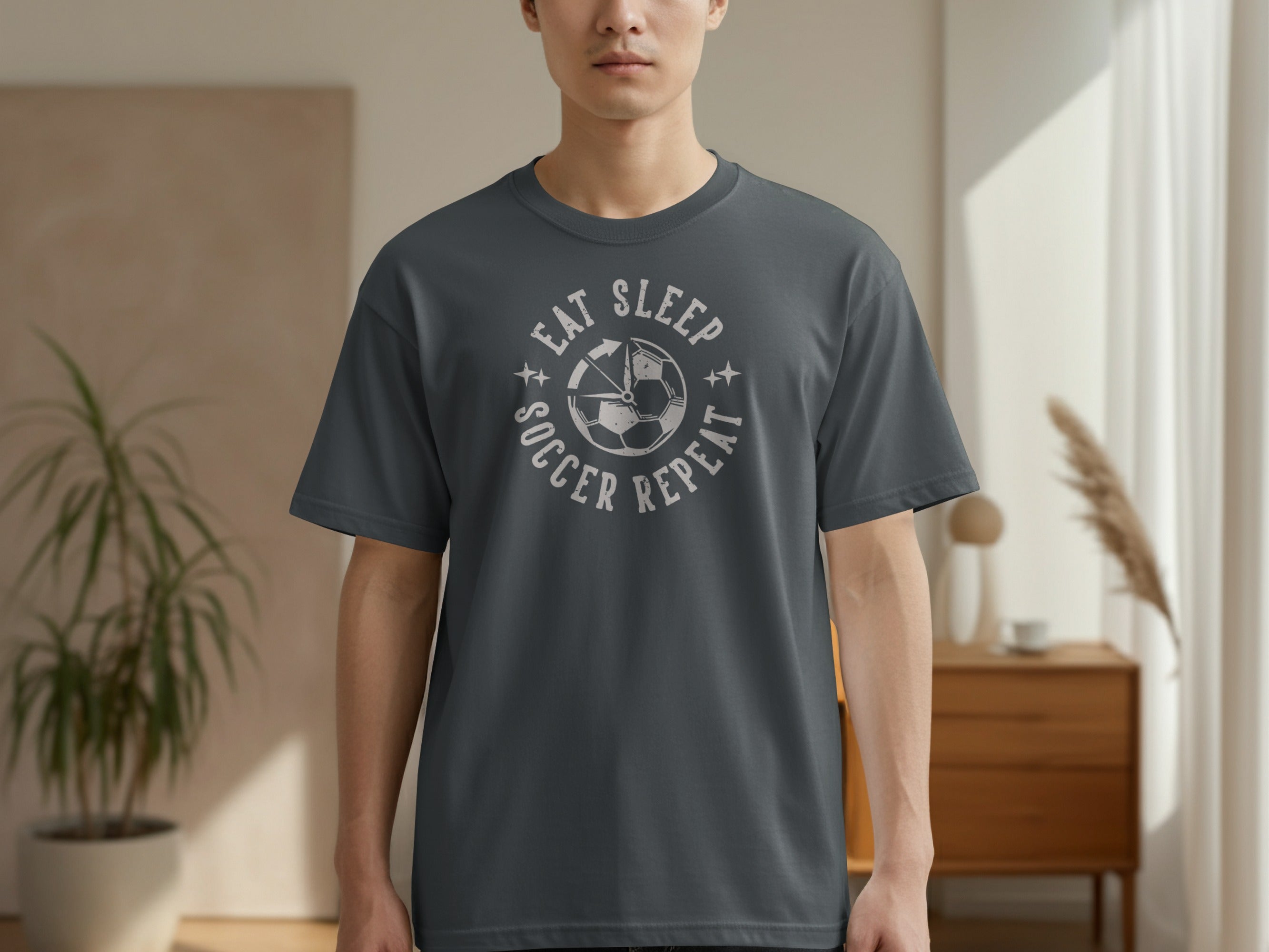 Dark grey t-shirt with "Eat Sleep Soccer Repeat" and soccer ball graphic.