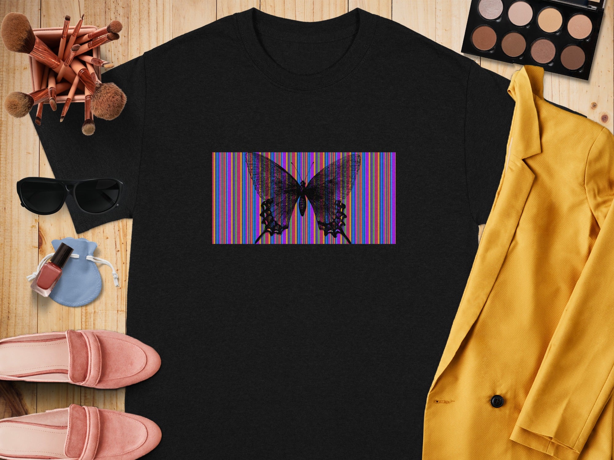 Black t-shirt with a purple, blue, green, yellow, and red striped rectangle featuring a black butterfly.