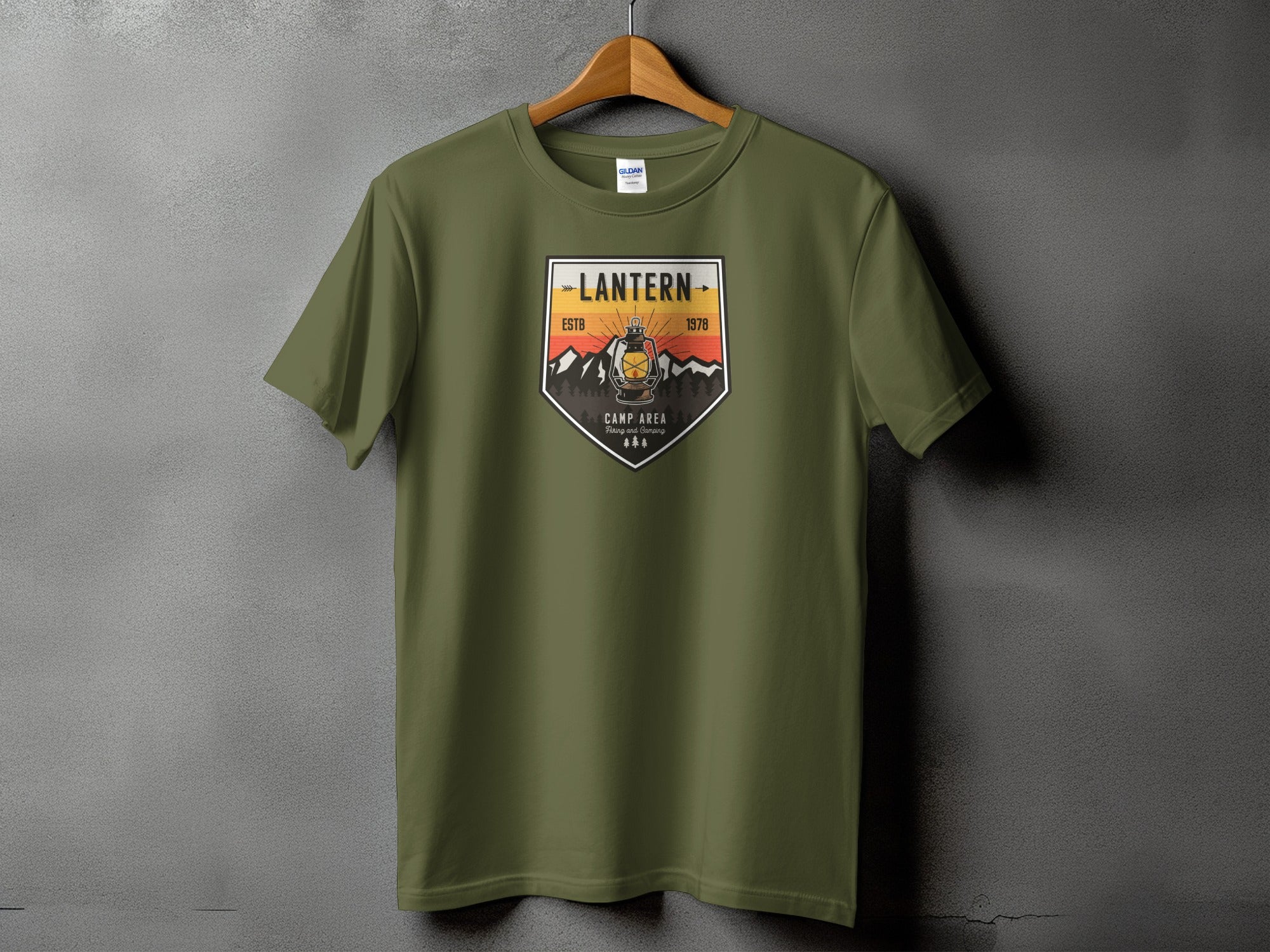 Olive green t-shirt with a "Lantern" badge featuring a vintage lantern and mountains.
