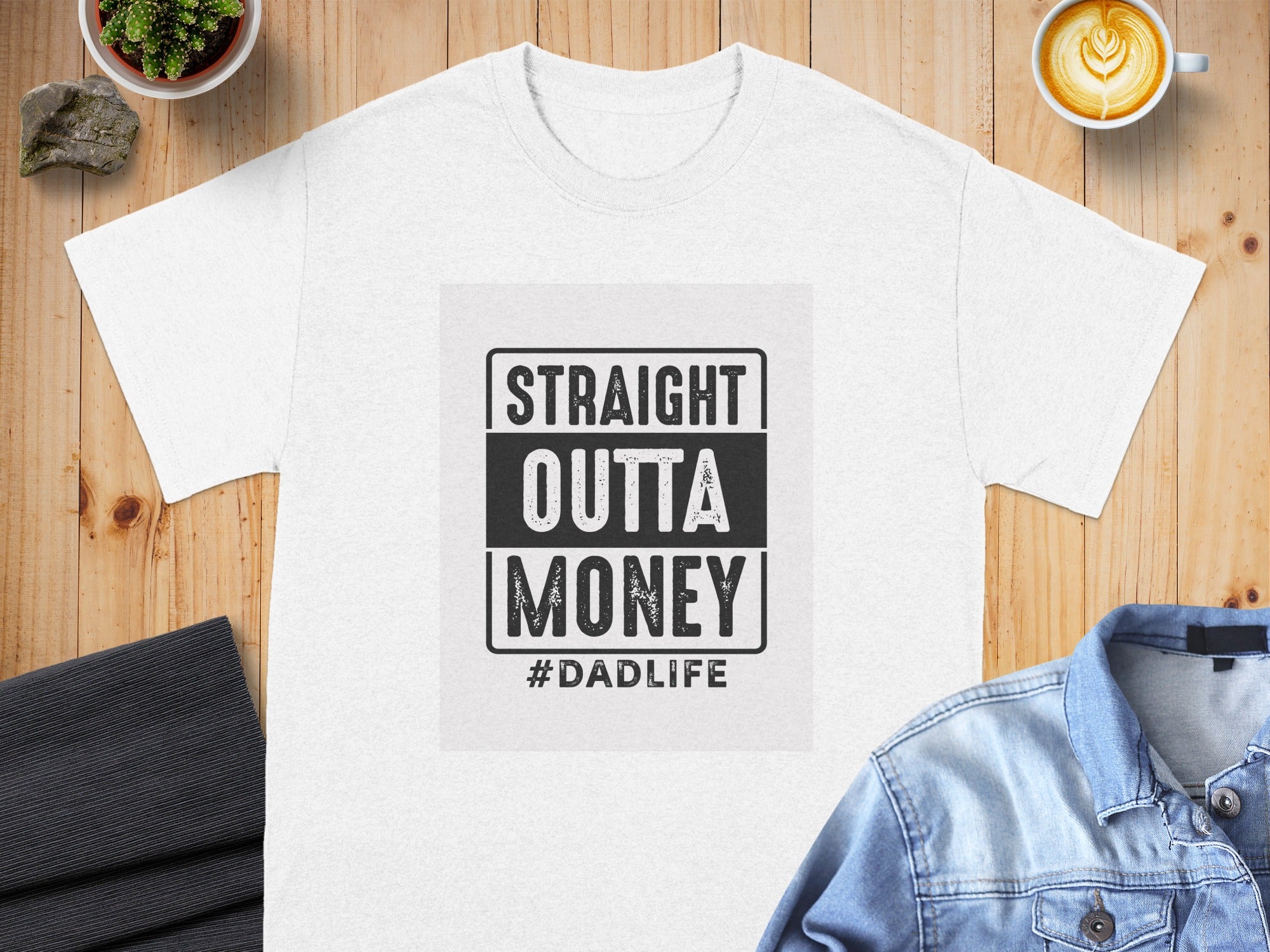 White t-shirt with black distressed text: "STRAIGHT OUTTA MONEY #DADLIFE"