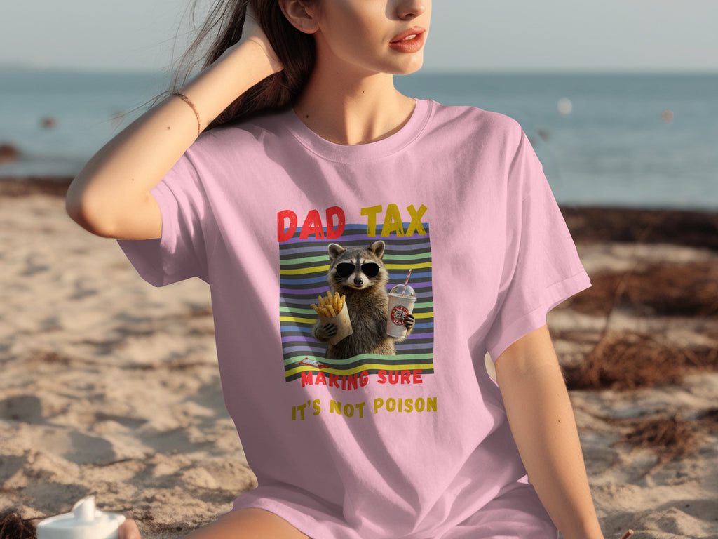 Pink t-shirt with raccoon, fries, and drink graphic that says "Dad Tax Making Sure It's Not Poison".