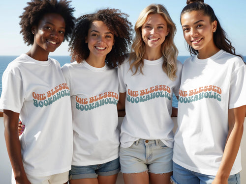 Four women smile wearing white t-shirts with "One Blessed Bookaholic" text.