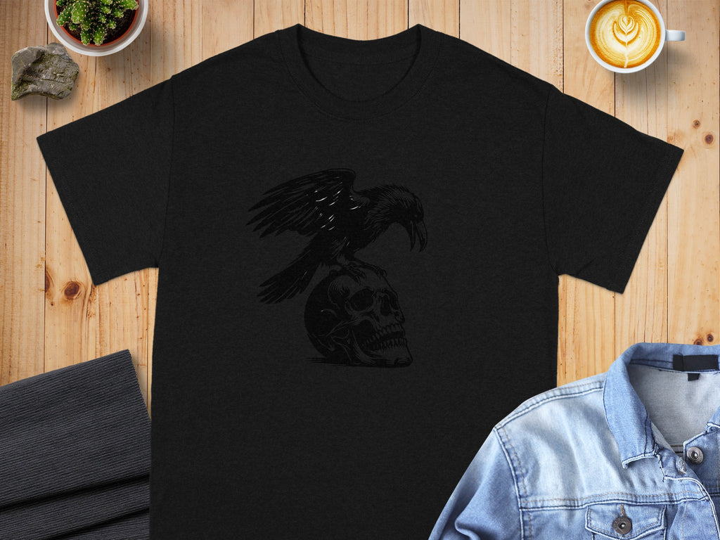 Black t-shirt with a raven perched on a skull graphic.