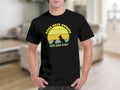 Black t-shirt with vintage sunset graphic and text: "Dogs Have Owners, Cats Have Staff".