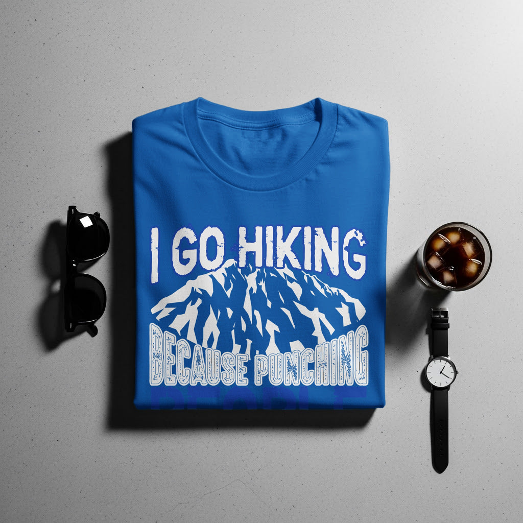 Blue t-shirt with white text "I GO HIKING BECAUSE PUNCHING" and mountain graphic.