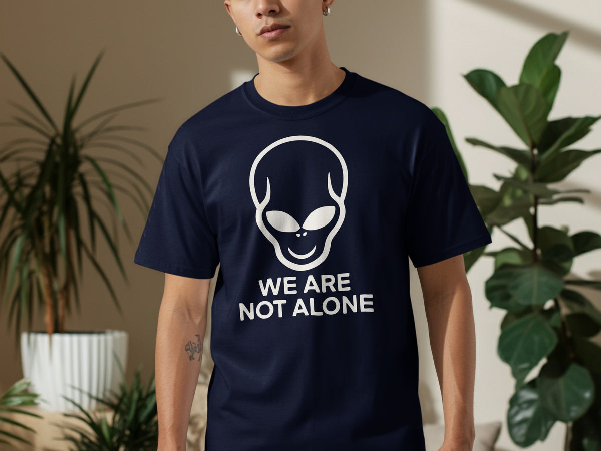 Navy t-shirt with white alien graphic and text "WE ARE NOT ALONE".