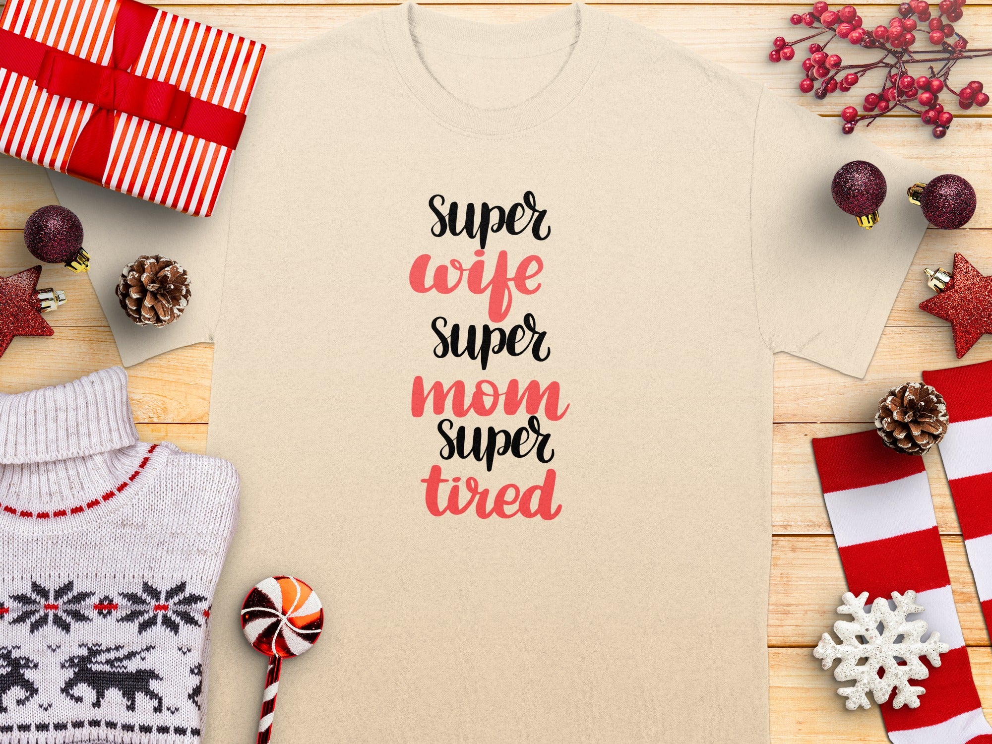 Cream t-shirt with text "Super wife super mom super tired" surrounded by Christmas decor.