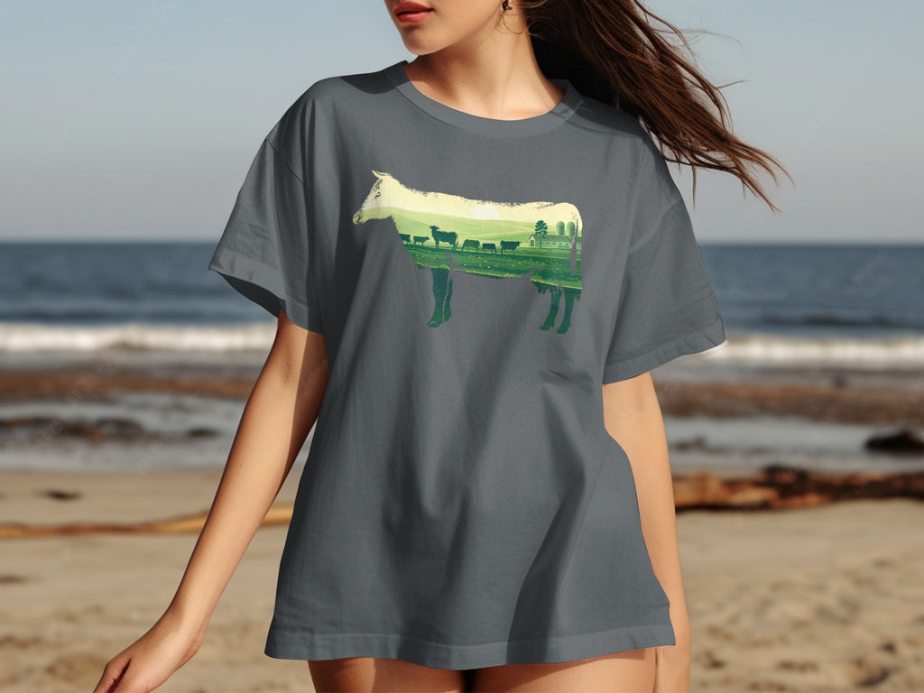 Dark grey t-shirt with a cow silhouette filled with a pastoral landscape scene.