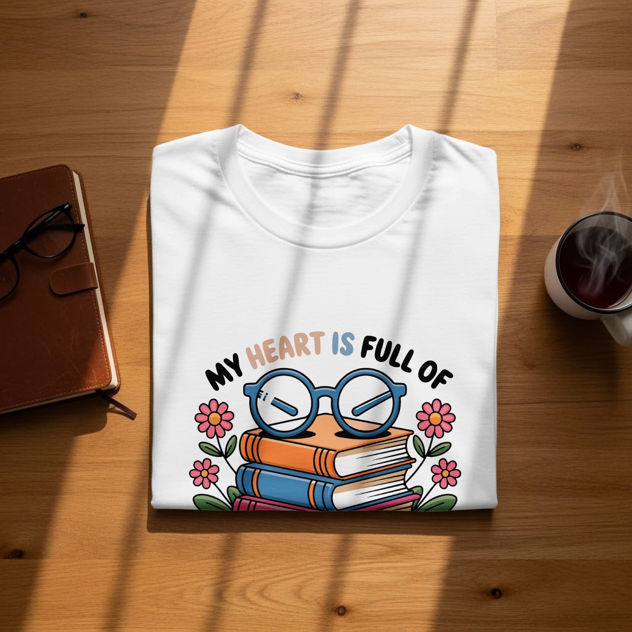 White t-shirt with cartoon books glasses and flowers design.