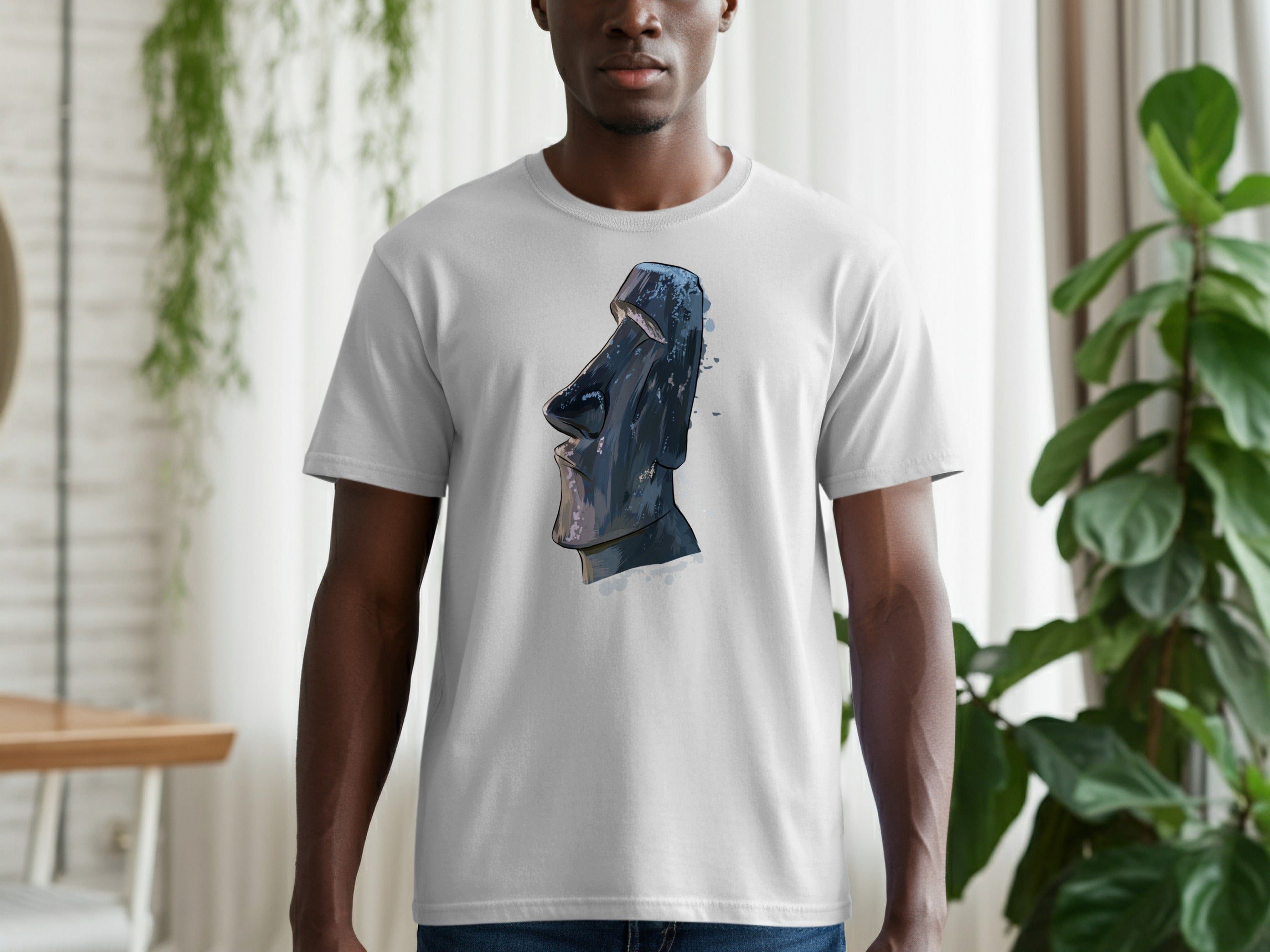 T-shirt featuring a stylized Moai statue illustration with watercolor accents.