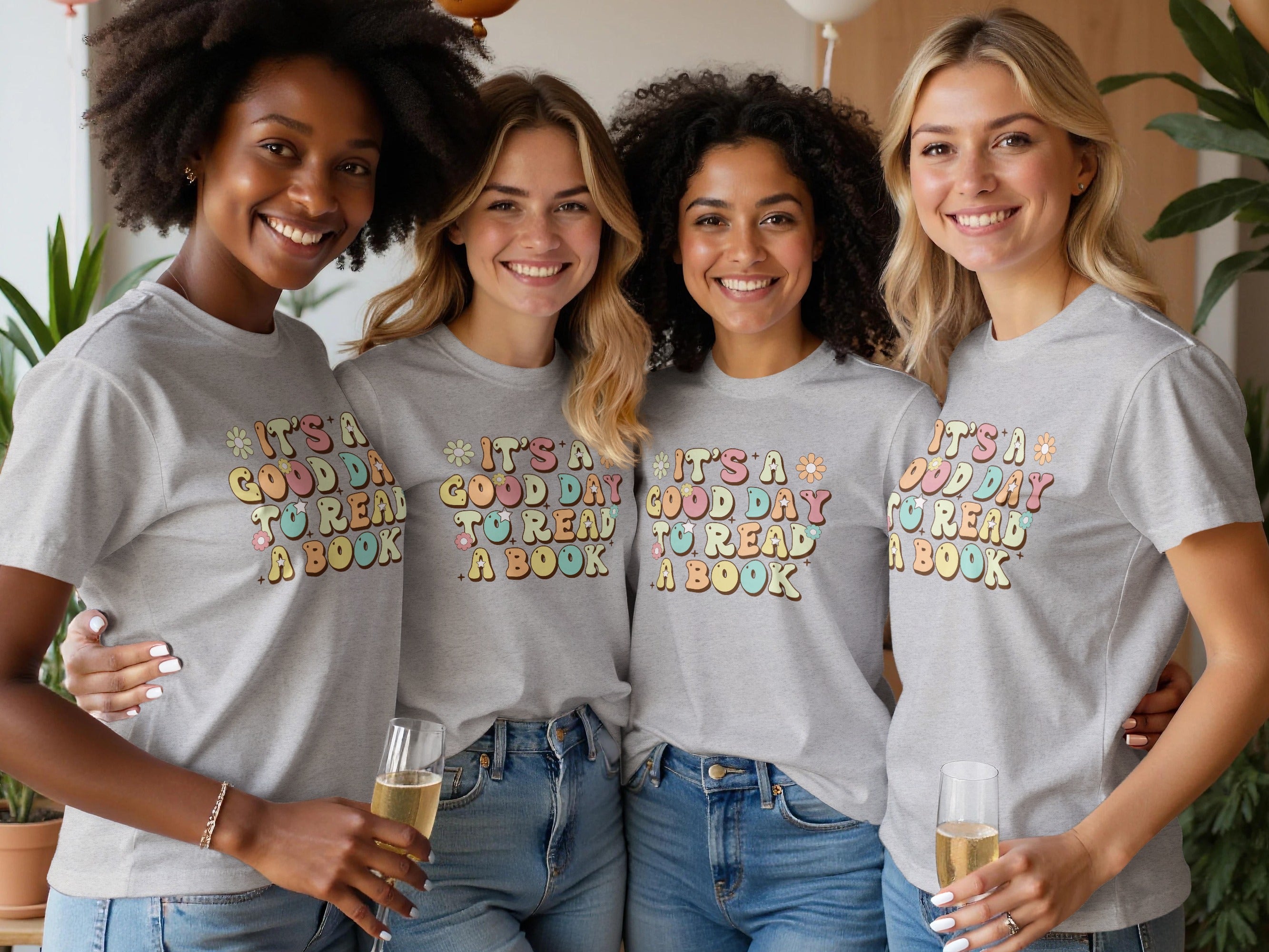 Four women in grey t-shirts with "It's a good day to read a book" graphic.