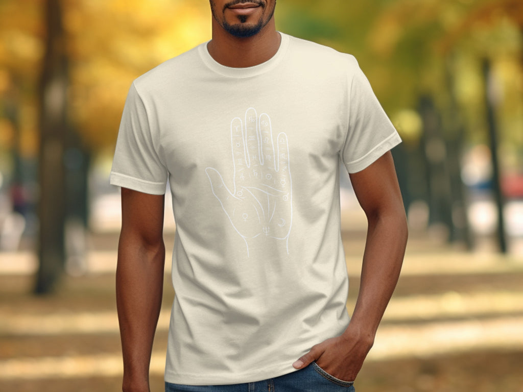 Cream t-shirt with white outline graphic of a palm with astrological and alchemical symbols.