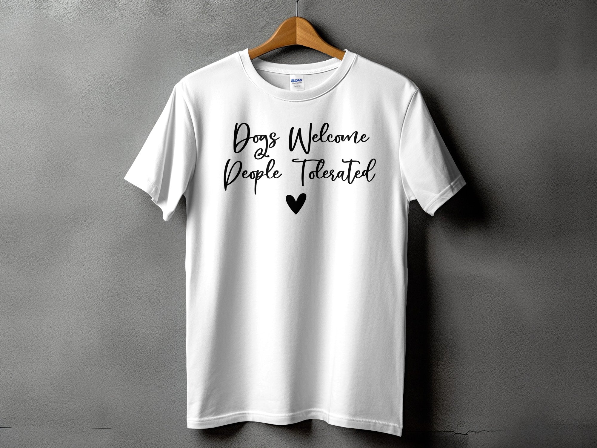 White t-shirt with black text "Dogs Welcome People Tolerated" and a heart.