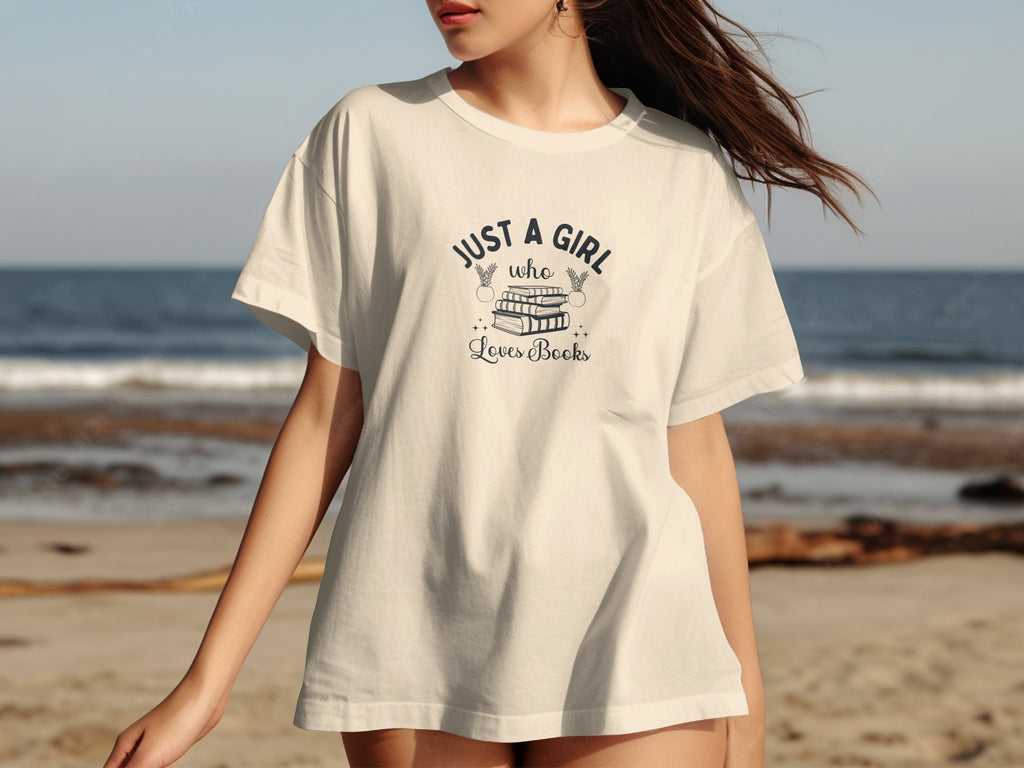 Cream t-shirt with text and stack of books graphic.