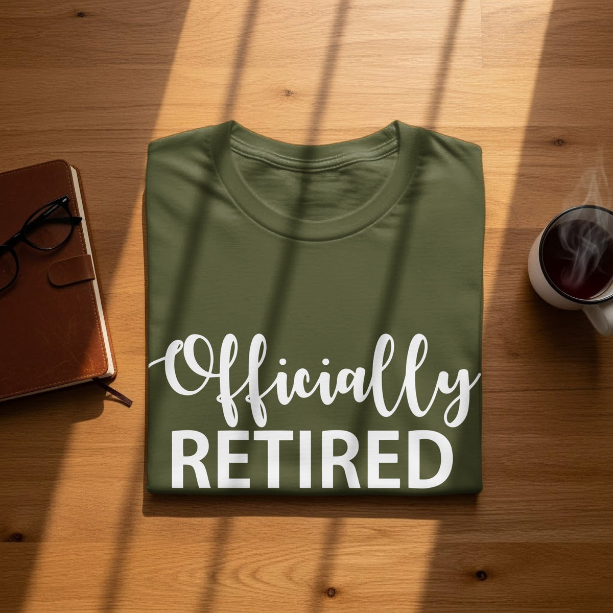 Green t-shirt with white text "Officially RETIRED".