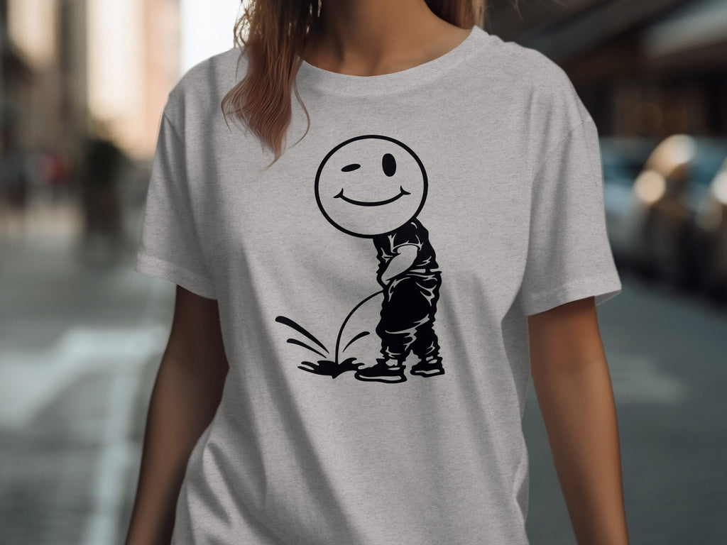 Light grey t-shirt with a black graphic of a winking smiley face urinating.