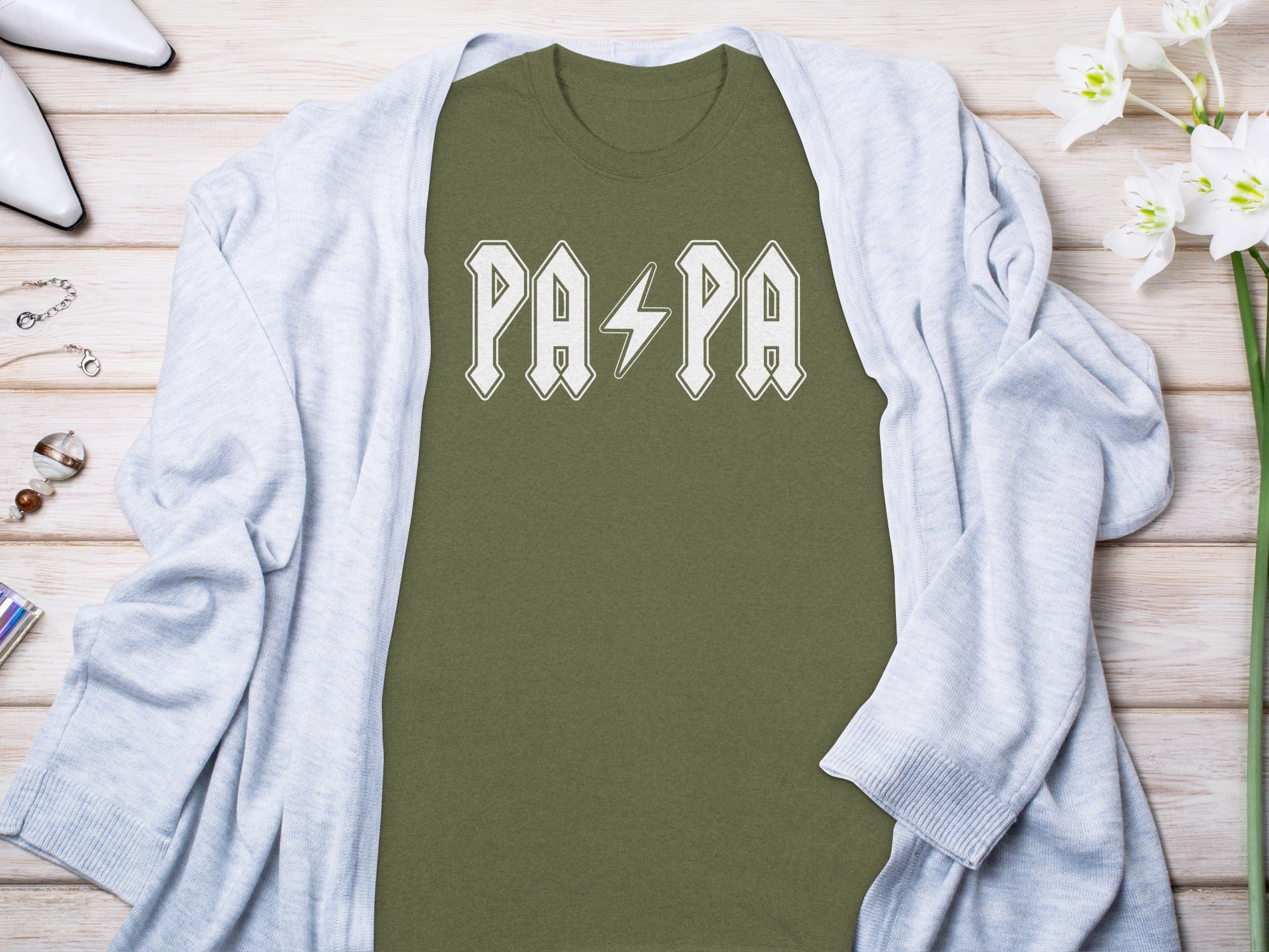 Green t-shirt with white "PAPA" text and a lightning bolt.
