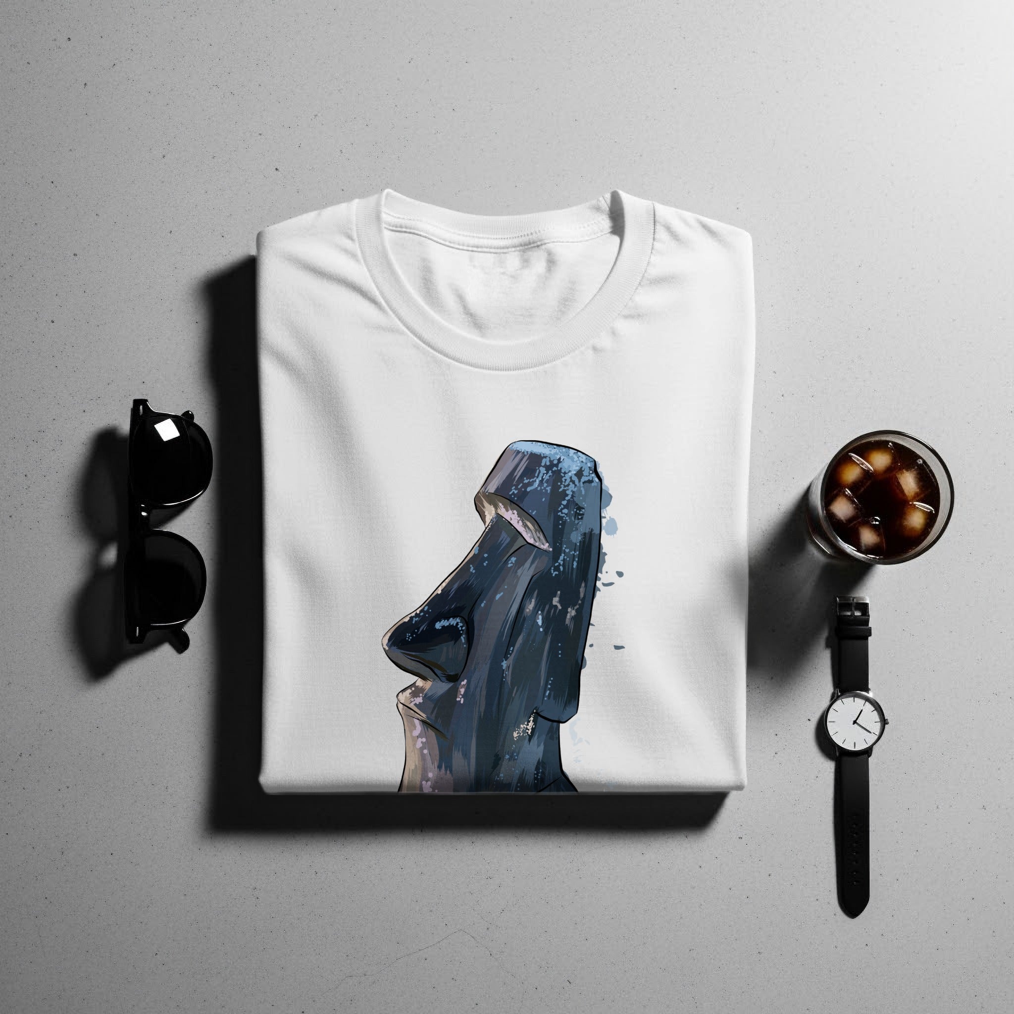 White t-shirt with a watercolor Moai statue graphic and watercolor splashes.