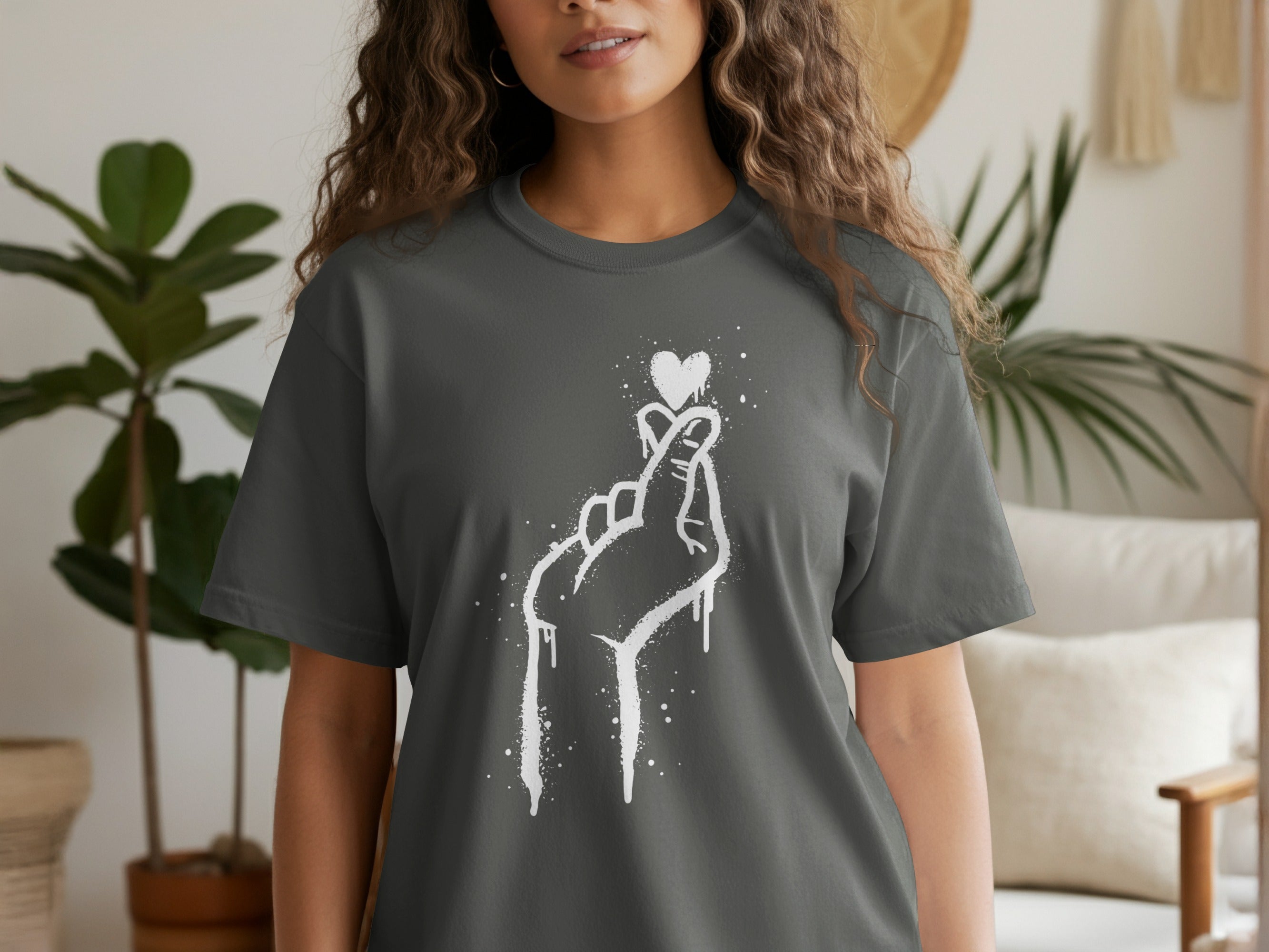 Dark grey t-shirt featuring a white dripping heart hand symbol graphic.