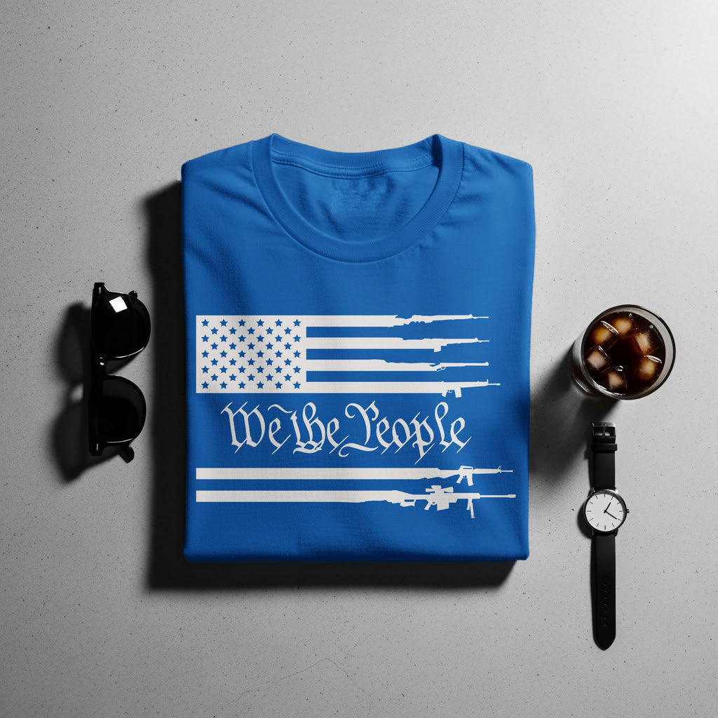 Blue t-shirt with white American flag and "We the People" design featuring rifles.