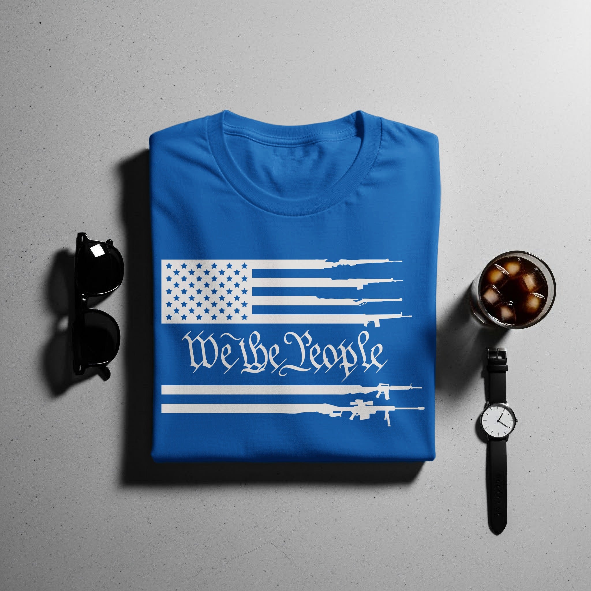 Blue t-shirt with white American flag and "We the People" design featuring rifles.