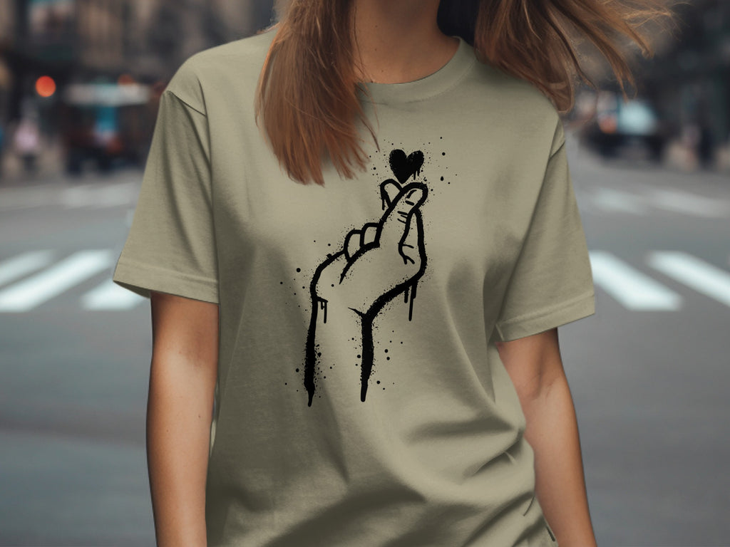 T-shirt with black spray paint style finger heart and heart graphic.