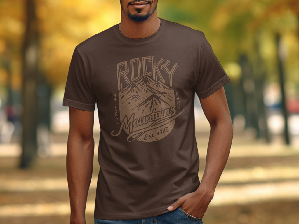 Brown t-shirt with RICKY NATIONAL PARK Mountains and Est. 1975 graphic.