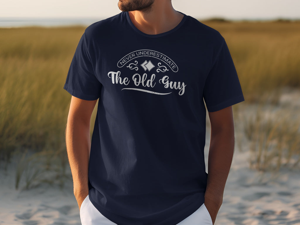 Navy t-shirt with "Never Underestimate The Old Guy" text on chest.