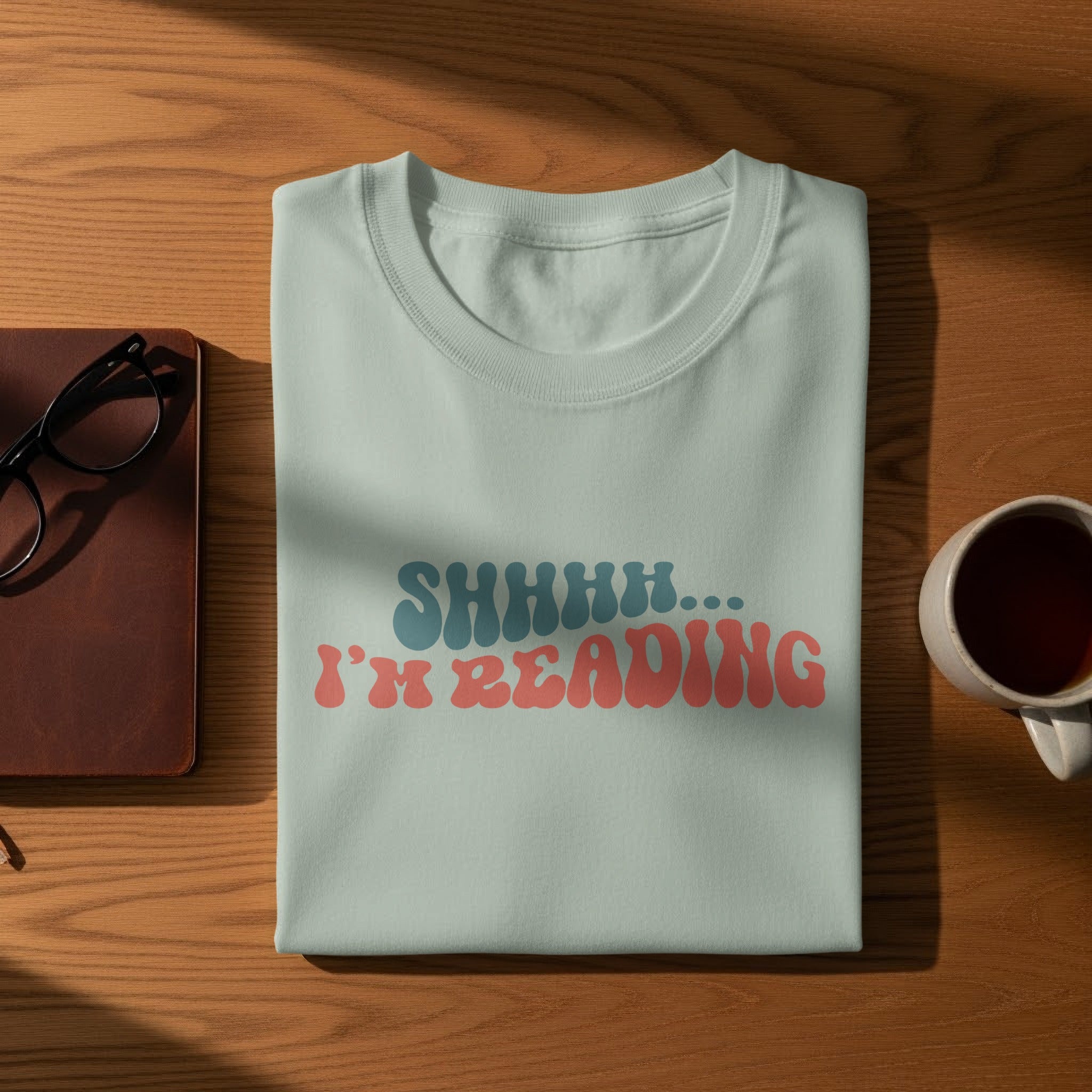 Light blue t-shirt with "SHHHH... I'M READING" text in red and blue.