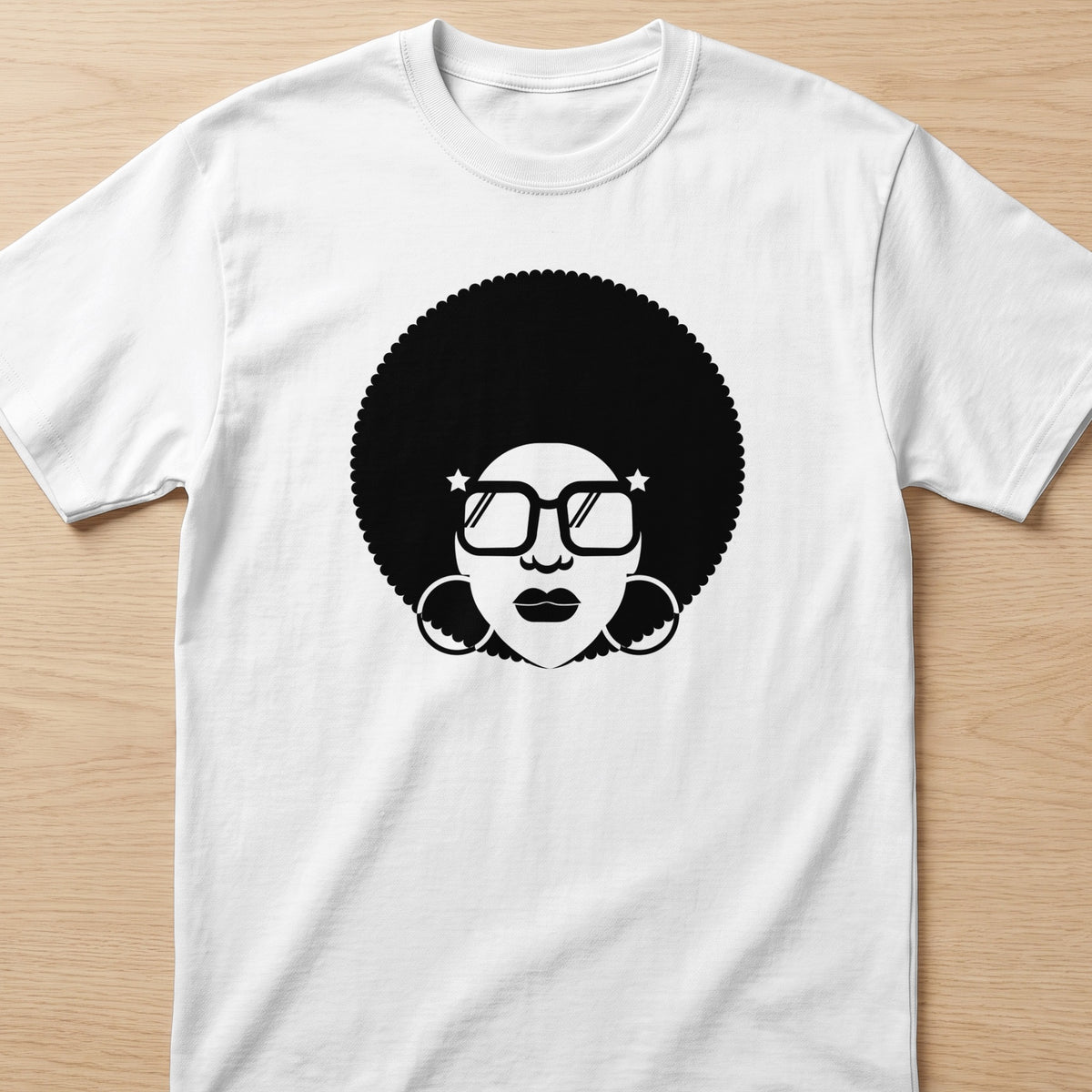 Black graphic of a woman with an afro, large hoop earrings, and square glasses on a white t-shirt.