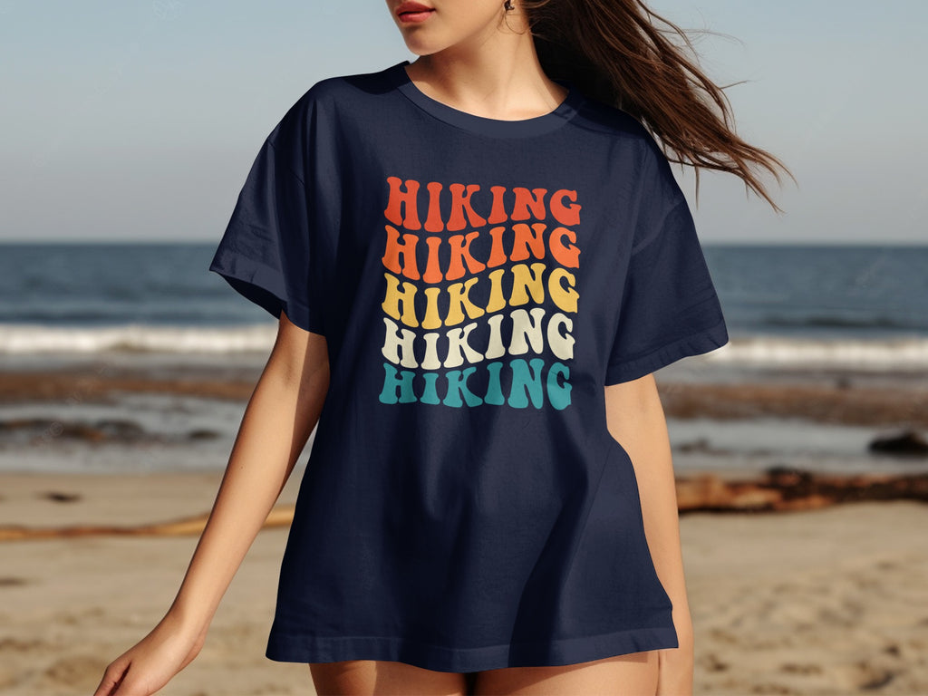 Navy t-shirt with "HIKING" in stacked retro font, orange, yellow, and teal.