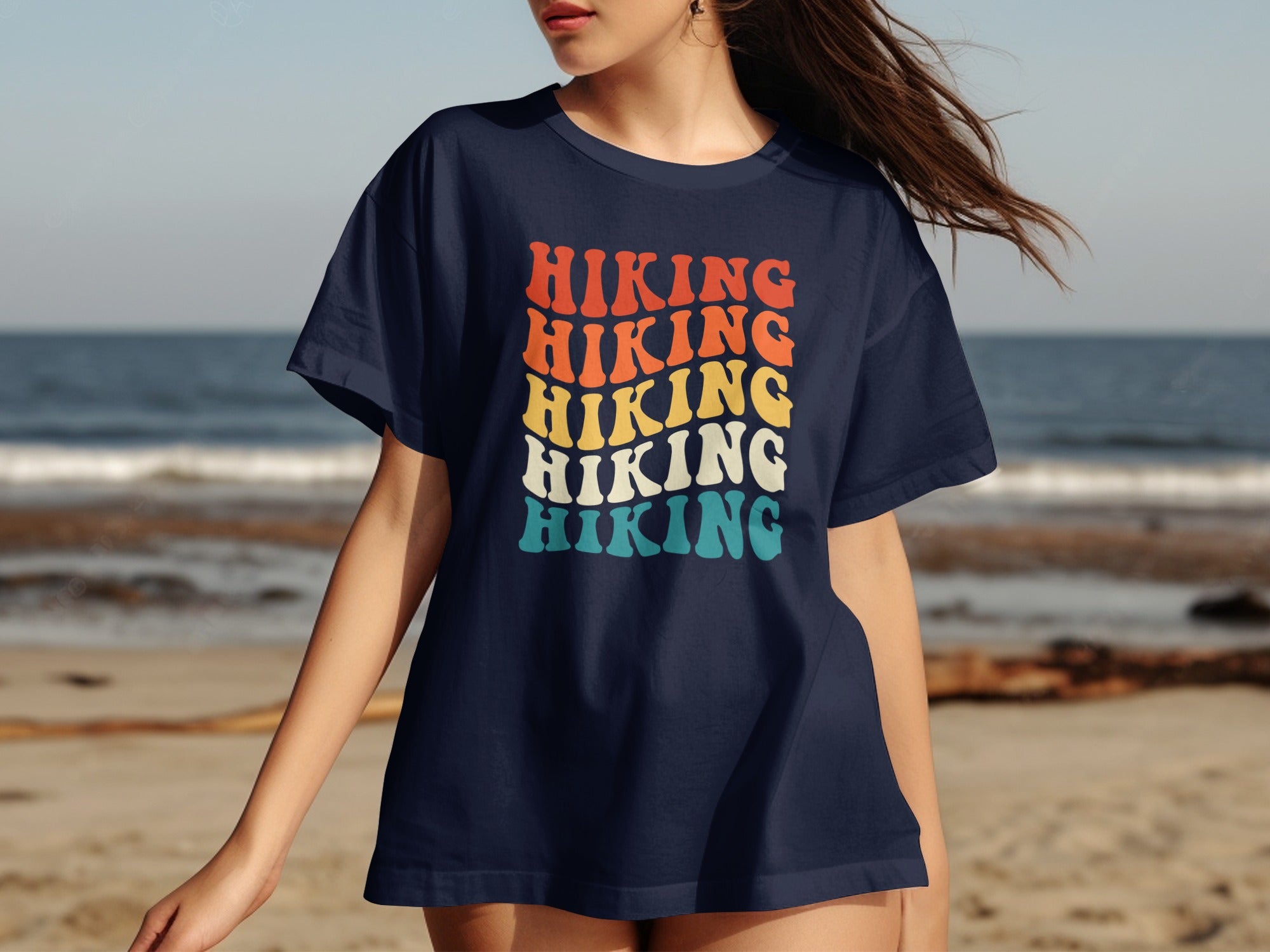 Navy t-shirt with "HIKING" in stacked retro font, orange, yellow, and teal.