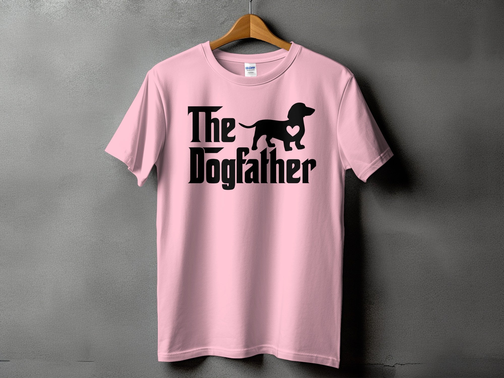 Pink t-shirt with black text and dachshund silhouette saying "The Dogfather".