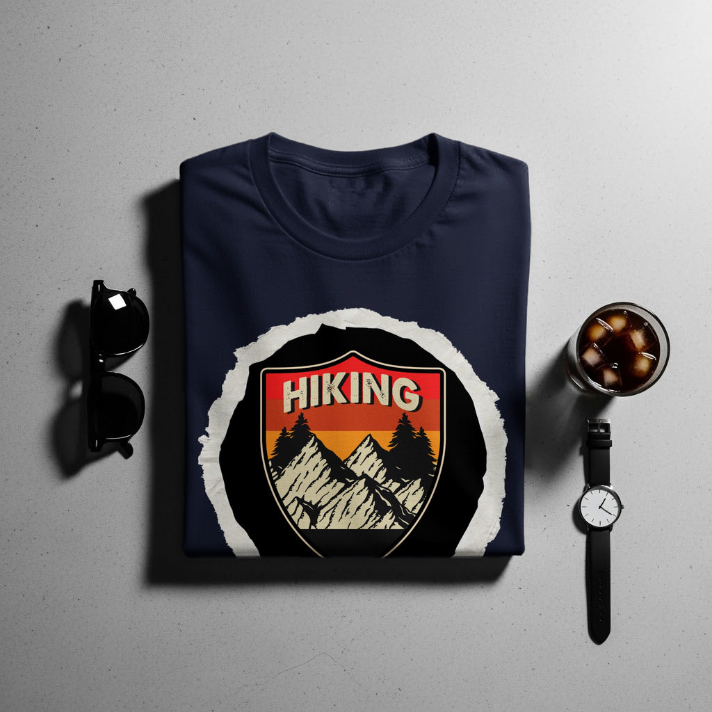 Navy t-shirt with a shield graphic featuring mountains, trees, and the word "HIKING".