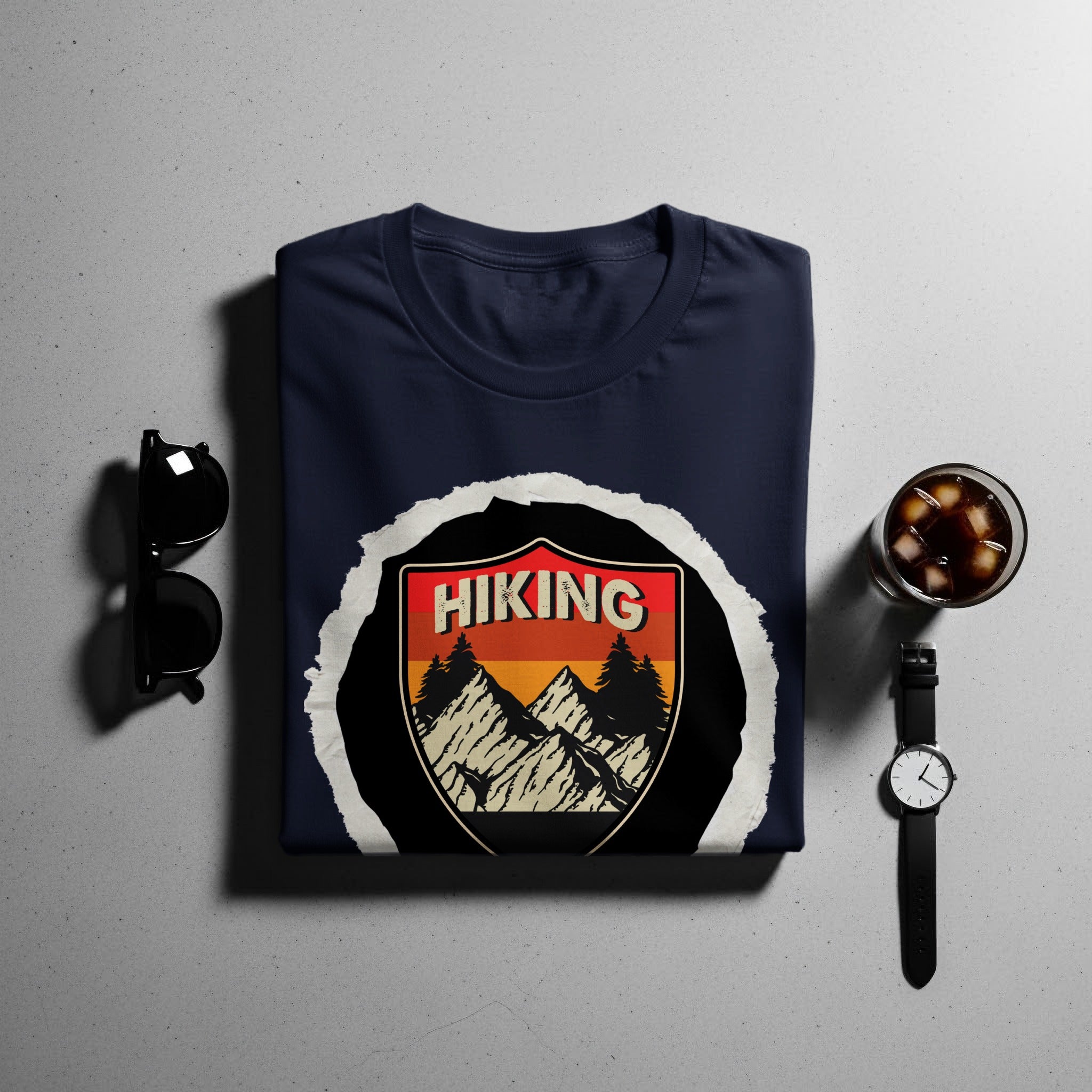 Navy t-shirt with a shield graphic featuring mountains, trees, and the word "HIKING".